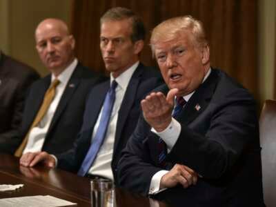 Then-President Donald Trump (right) with Nebraska Gov. Pete Ricketts (left) and South Dakota Republican Sen. John Thune (center) during a meeting on April, 12, 2018, in Washington, D.C.