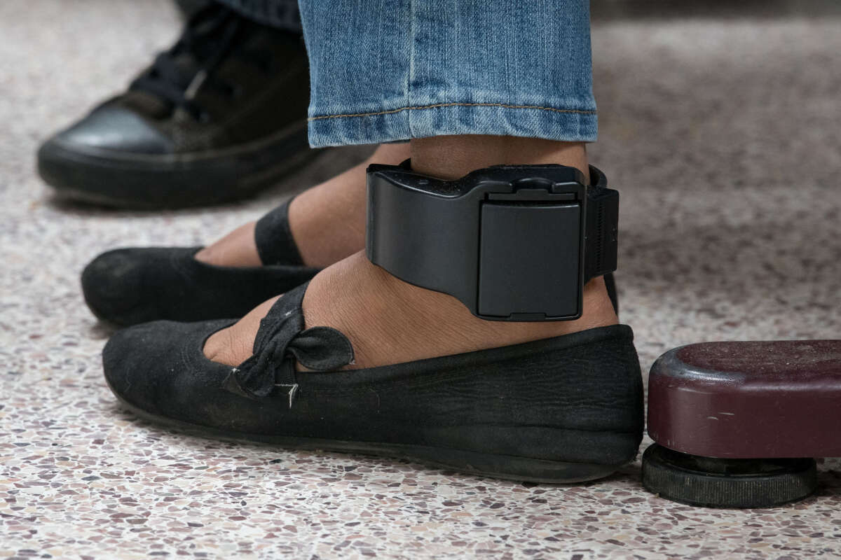 An ankle monitor is seen on a woman from El Salvador, recently released from federal detention with fellow Central American asylum seekers, at a bus depot on June 12, 2019, in McAllen, Texas.