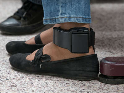 An ankle monitor is seen on a woman from El Salvador, recently released from federal detention with fellow Central American asylum seekers, at a bus depot on June 12, 2019, in McAllen, Texas.