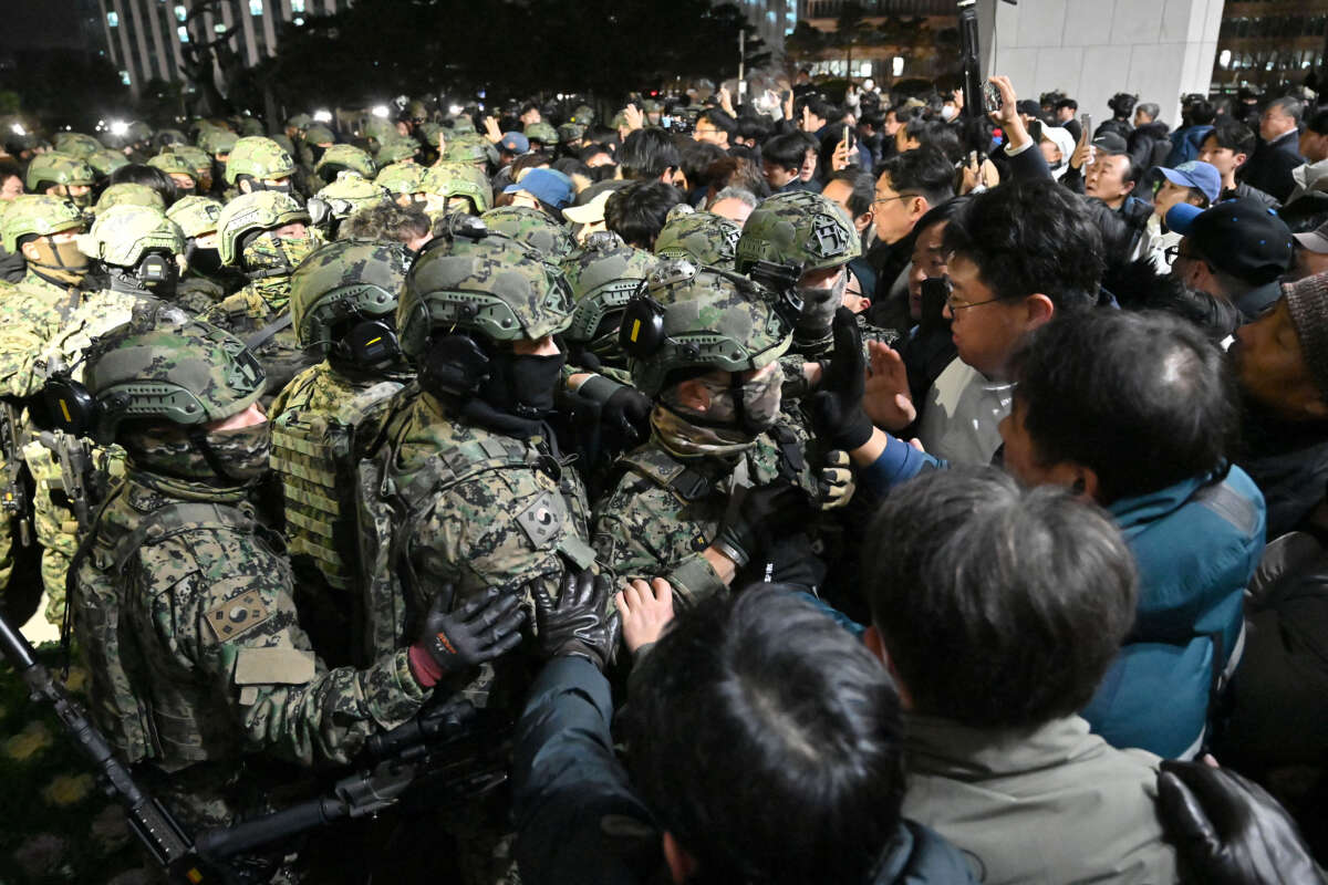 Soldiers try to enter the National Assembly building in Seoul on December 4, 2024, after South Korea President Yoon Suk Yeol declared martial law.