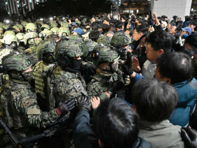 Soldiers try to enter the National Assembly building in Seoul on December 4, 2024, after South Korea President Yoon Suk Yeol declared martial law.