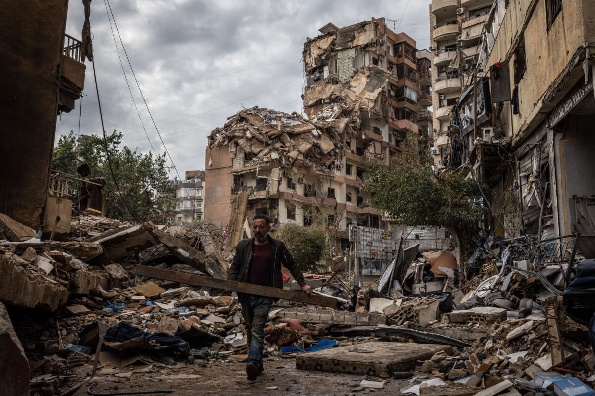 A local man salvages items from the rubble opposite a building destroyed by an Israeli airstrike on a street that goes through the middle of Dahieh on November 29, 2024, in Beirut, Lebanon.