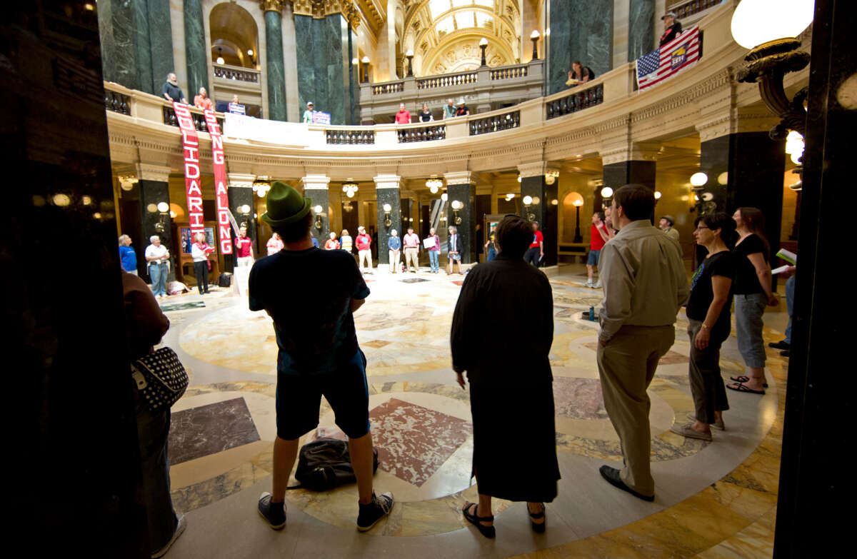 In Madison, Wisconsin, May 22, 2012, people sing traditional protest songs like We Shall Overcome in the Capitol Rotunda.