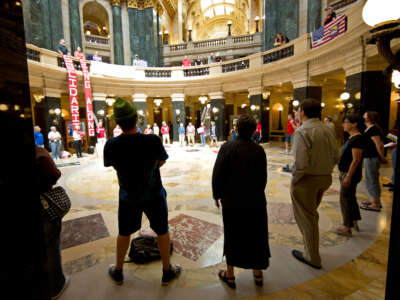 In Madison, Wisconsin, May 22, 2012, people sing traditional protest songs like We Shall Overcome in the Capitol Rotunda.