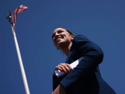 Rep. Alexandria Ocasio-Cortez listens to speakers during an event outside Union Station on June 16, 2021, in Washington, D.C.