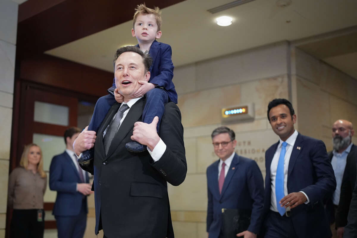 Tesla CEO Elon Musk, Co-Chair of the newly announced Department of Government Efficiency (DOGE) carries his son X on his shoulders at the U.S. Capitol after a media availability with businessman Vivek Ramaswamy (2nd right), co-Chair of the newly announced department, and Speaker of the House Mike Johnson (3rd right), on December 5, 2024, in Washington, D.C.