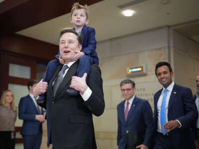 Tesla CEO Elon Musk, Co-Chair of the newly announced Department of Government Efficiency (DOGE) carries his son X on his shoulders at the U.S. Capitol after a media availability with businessman Vivek Ramaswamy (2nd right), co-Chair of the newly announced department, and Speaker of the House Mike Johnson (3rd right), on December 5, 2024, in Washington, D.C.