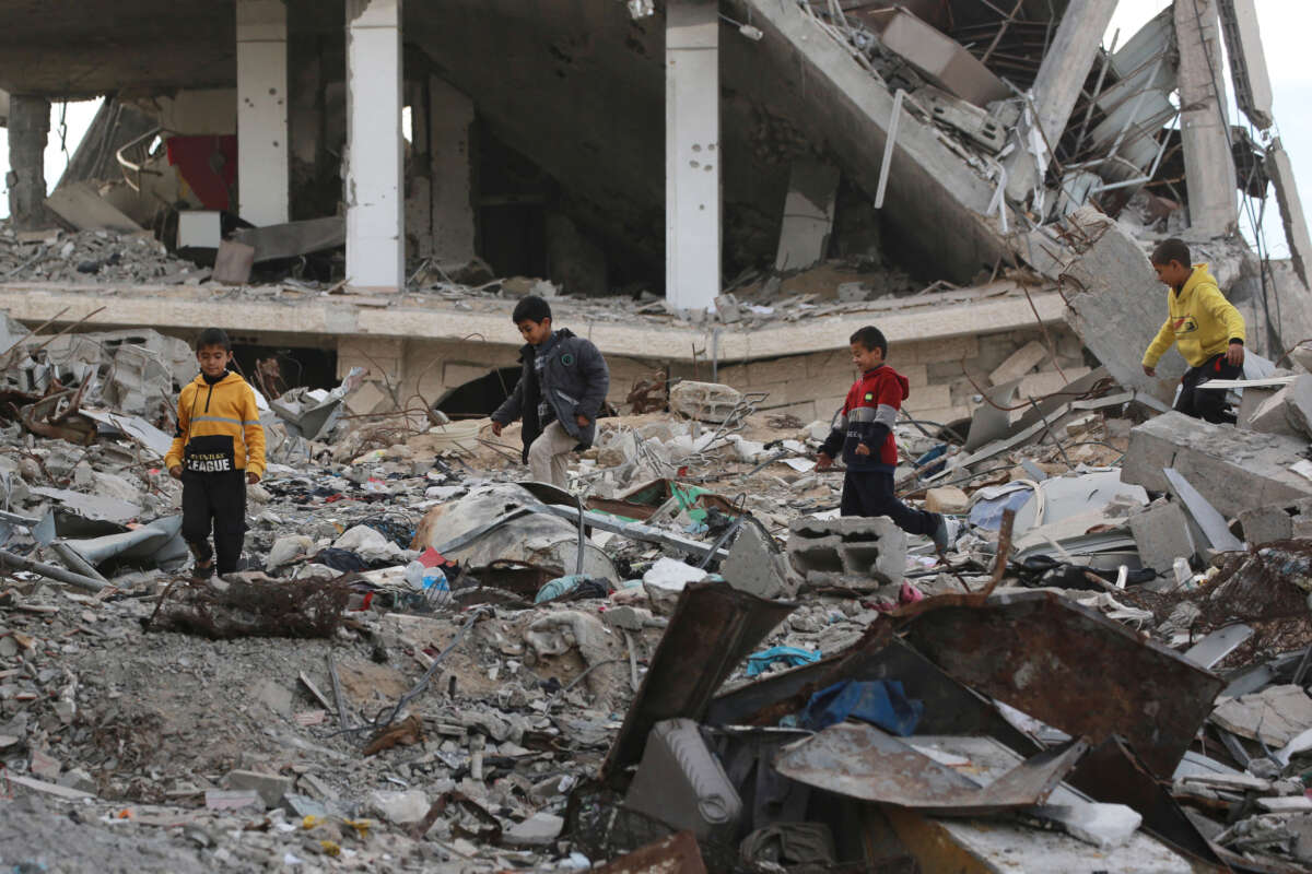 Palestinian children play in the rubble of a building destroyed during previous Israeli bombardment, in Khan Yunis in the south Gaza Strip, on December 10, 2024.