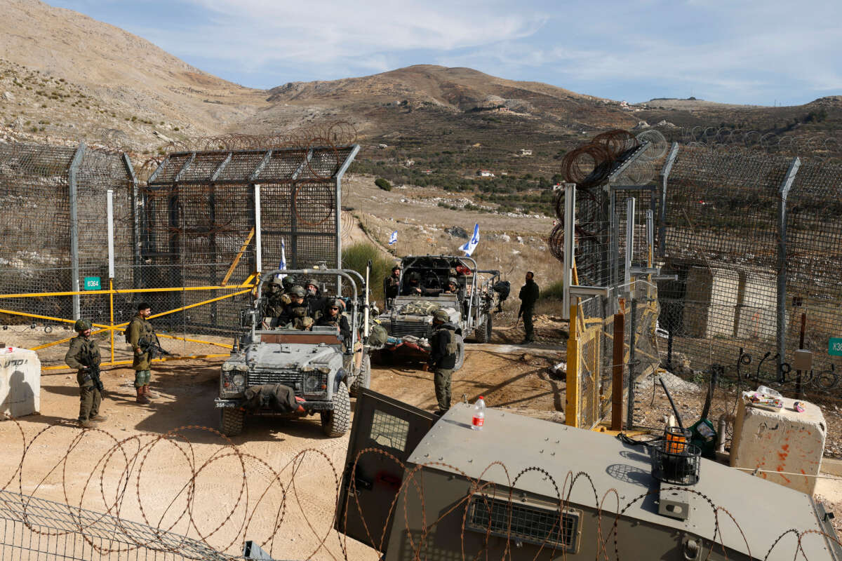 Israeli military vehicles cross the fence as they return from the buffer zone with Syria, near the Druze village of Majdal Shams in the Israel-annexed Golan Heights, on December 10, 2024.