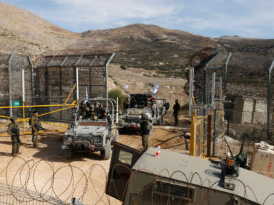 Israeli military vehicles cross the fence as they return from the buffer zone with Syria, near the Druze village of Majdal Shams in the Israel-annexed Golan Heights, on December 10, 2024.