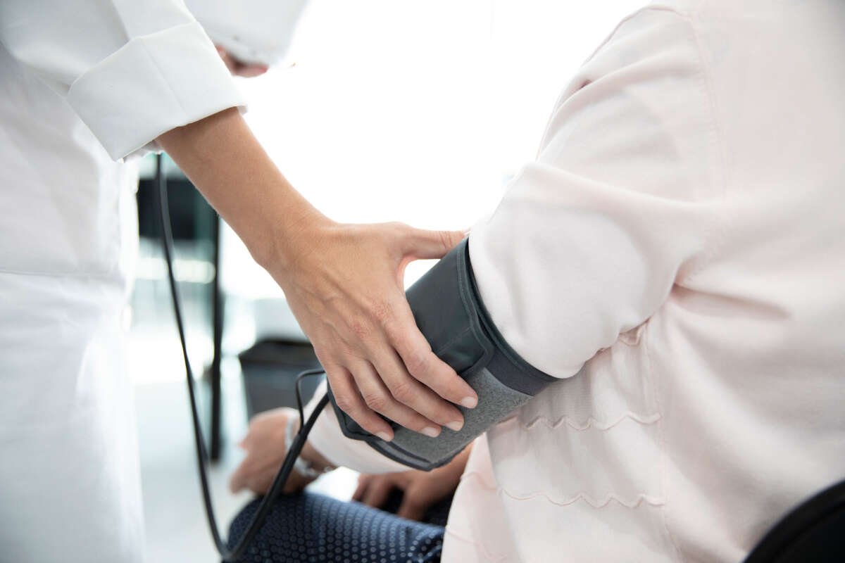 Person has blood pressure checked in medical check-up