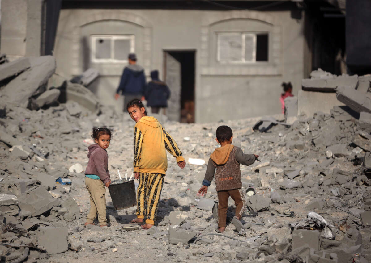 Palestinian children walk among the rubble of a building, destroyed in an Israeli strike, in the Nuseirat refugee Camp in the central Gaza Strip on December 7, 2024.