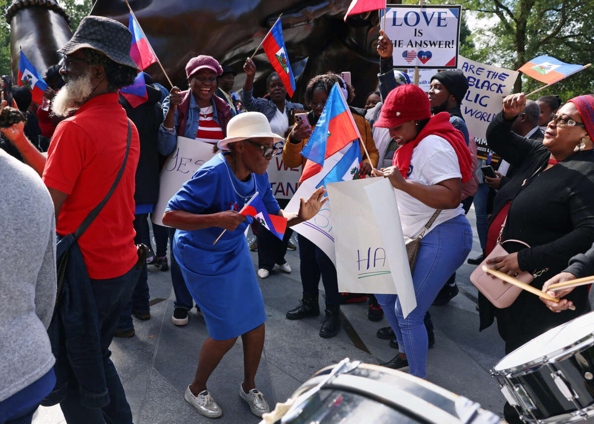 Haitian-Americans of all ages dance during a street protest