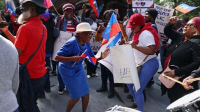 Haitian-Americans of all ages dance during a street protest