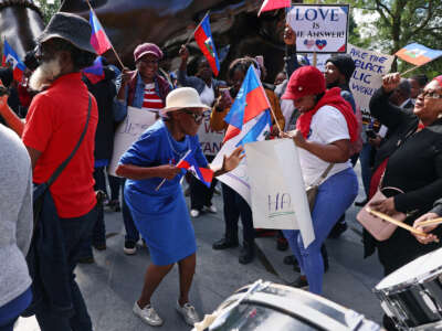 Haitian-Americans of all ages dance during a street protest