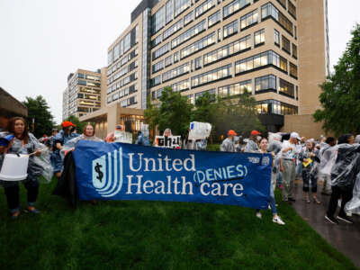 Health care advocates risk arrest protesting care denials at UnitedHealthcare on July 15, 2024, in Minnetonka, Minnesota.