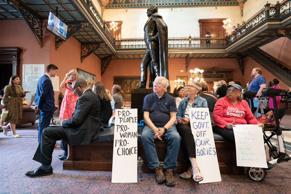 Demonstrators watch a live video feed of state Senate proceedings before the body passed a ban on abortion after six weeks of pregnancy at the South Carolina Statehouse on May 23, 2023, in Columbia, South Carolina.