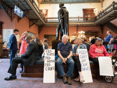 Demonstrators watch a live video feed of state Senate proceedings before the body passed a ban on abortion after six weeks of pregnancy at the South Carolina Statehouse on May 23, 2023, in Columbia, South Carolina.