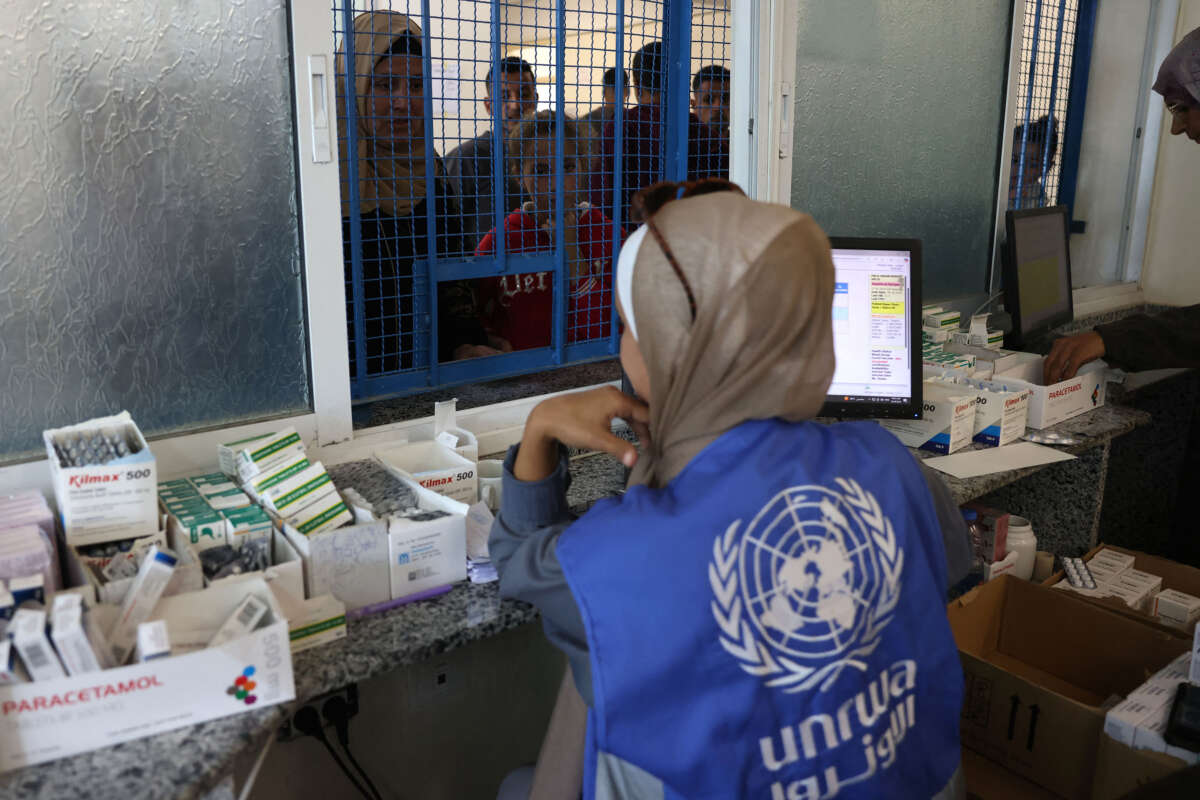 Palestinians queue to receive medicine at the UNRWA Japanese Health Center in Khan Yunis on the southern Gaza Strip on October 29, 2024.