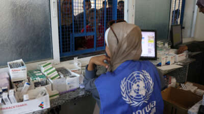 Palestinians queue to receive medicine at the UNRWA Japanese Health Center in Khan Yunis on the southern Gaza Strip on October 29, 2024.