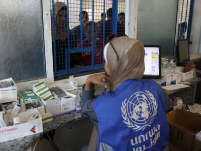 Palestinians queue to receive medicine at the UNRWA Japanese Health Center in Khan Yunis on the southern Gaza Strip on October 29, 2024.