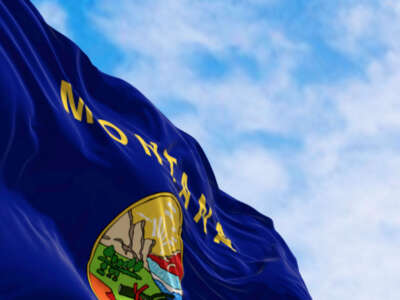 Montana state flag billowing over blue sky