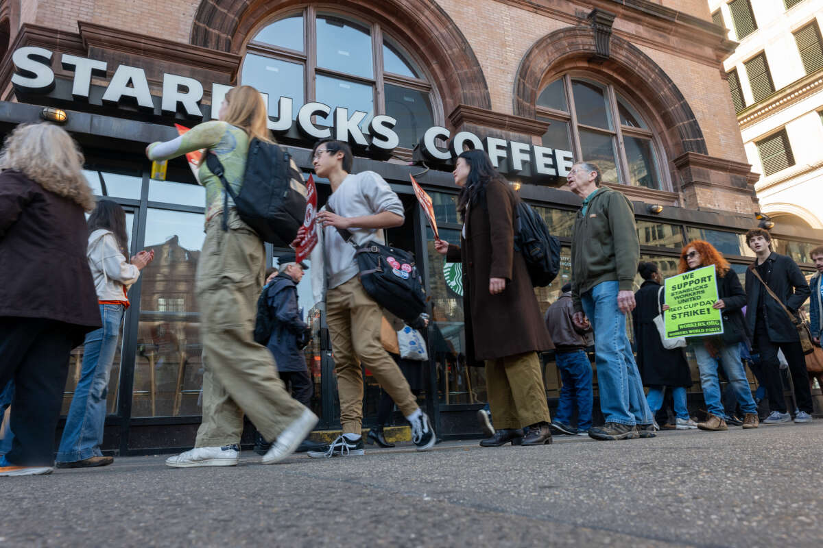 People picket outside of a Starbucks store in New York's East Village on November 16, 2023, in New York City.