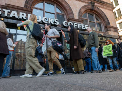 People picket outside of a Starbucks store in New York's East Village on November 16, 2023, in New York City.