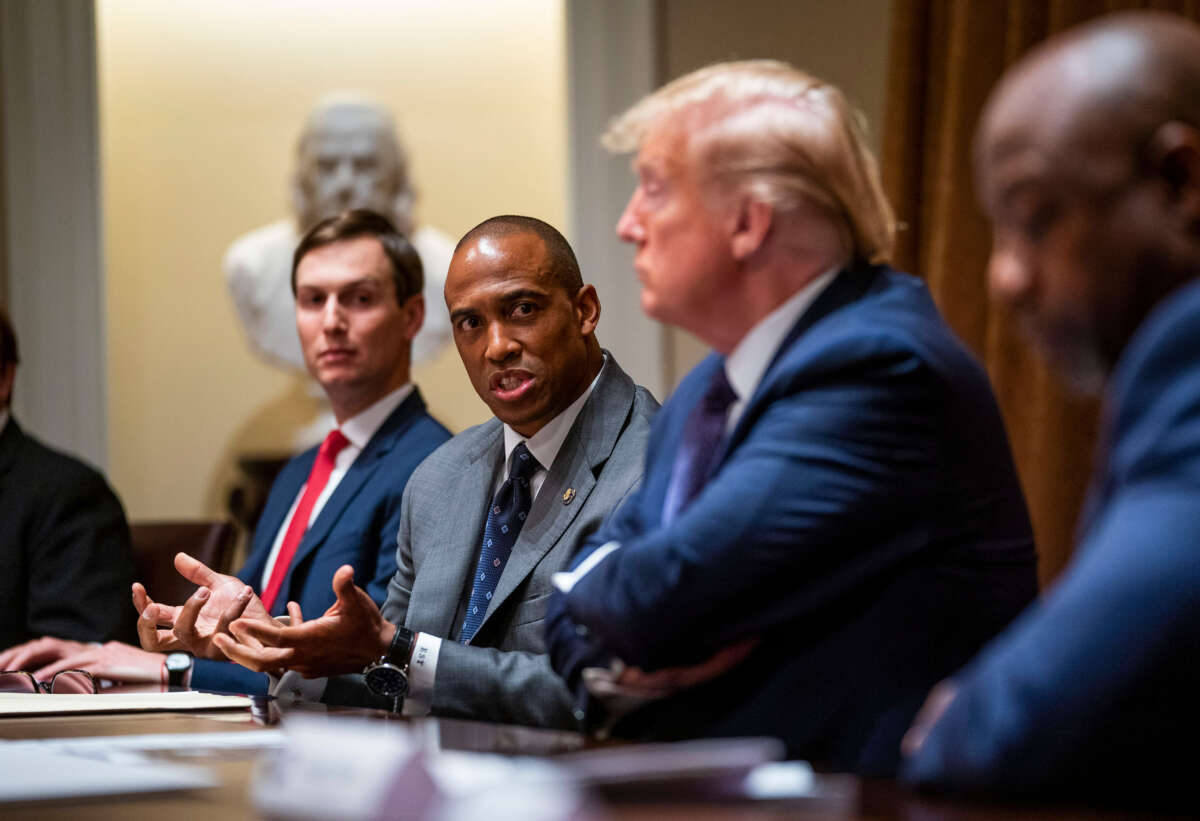 Then-Executive Director of the White House Opportunity and Revitalization Council Scott Turner speaks as President Donald Trump and senior adviser Jared Kushner listen during a meeting in the Cabinet Room of the White House, May 18, 2020, in Washington, D.C.