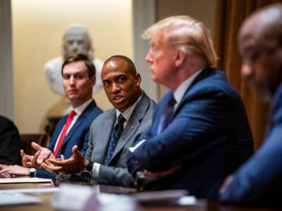 Then-Executive Director of the White House Opportunity and Revitalization Council Scott Turner speaks as President Donald Trump and senior adviser Jared Kushner listen during a meeting in the Cabinet Room of the White House, May 18, 2020, in Washington, D.C.