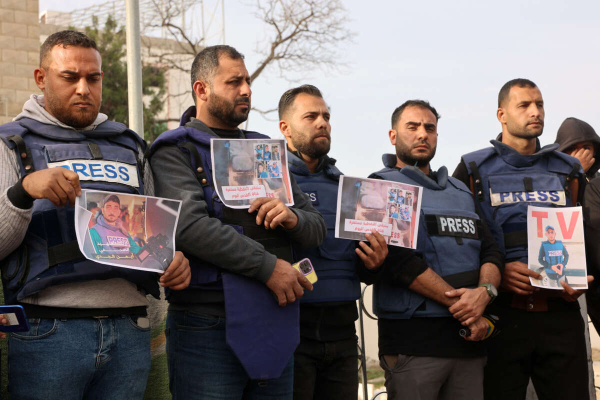 Members of the press stand in solidarity after an Israeli missile hit a media broadcast truck in Nuseirat, on December 26, 2024, outside the Baptist Hospital in Gaza City.