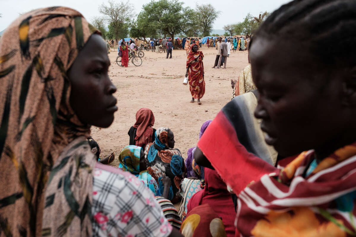 People wait to receive food cards after registering as new arrivals at a camp for internally displaced persons in Agari, South Kordofan, on June 17, 2024.