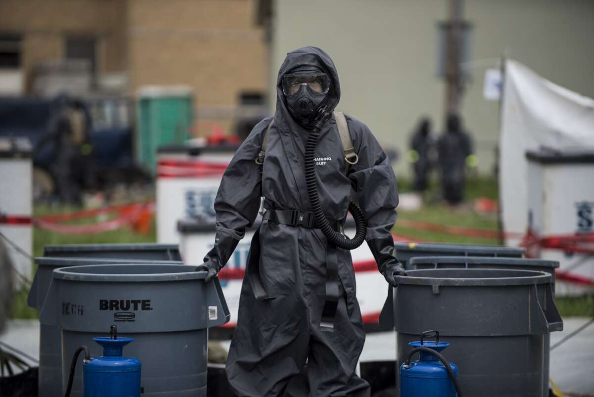 A U.S. Army Soldier with the 51st Chemical Biological Radiological Nuclear Company, of Fort Stewart, Georgia, stands watch at a decontamination field site at the Muscatatuck Urban Training Center, Indiana.