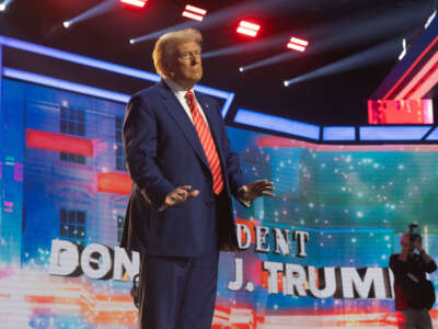 President-elect Donald Trump dances during Turning Point USA's AmericaFest at the Phoenix Convention Center on December 22, 2024, in Phoenix, Arizona.