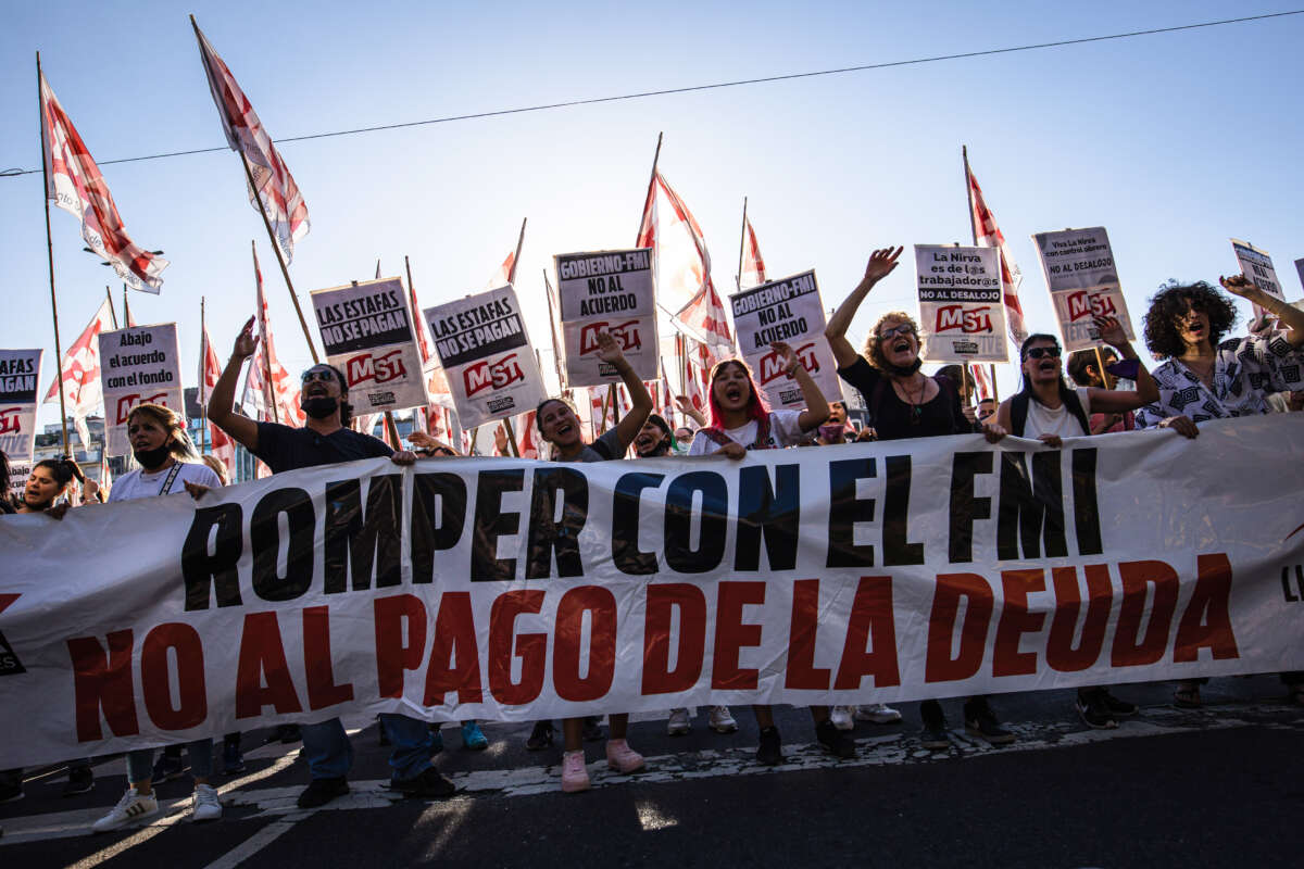 Militants of the Socialist Workers Movement (MST) carry a banner demanding rejection of the International Monetary Fund (IMF) and Argentina's foreign debt in Buenos Aires, Argentina, on February 8, 2022.