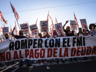 Militants of the Socialist Workers Movement (MST) carry a banner demanding rejection of the International Monetary Fund (IMF) and Argentina's foreign debt in Buenos Aires, Argentina, on February 8, 2022.