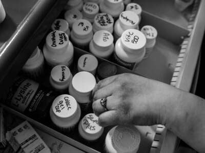 Johanna Meneses, 32, grabs over the counter medications for her patients at Twilight Gardens nursing home in Norwalk, Ohio, on March 4, 2023.