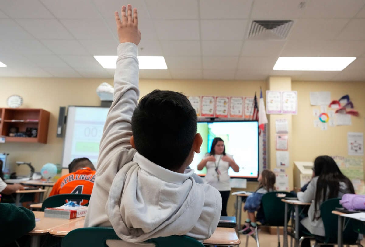 A fourth-grade dual language student raises his hand during class in Spanish on October 19, 2023, at Patterson Elementary School in Houston, Texas.