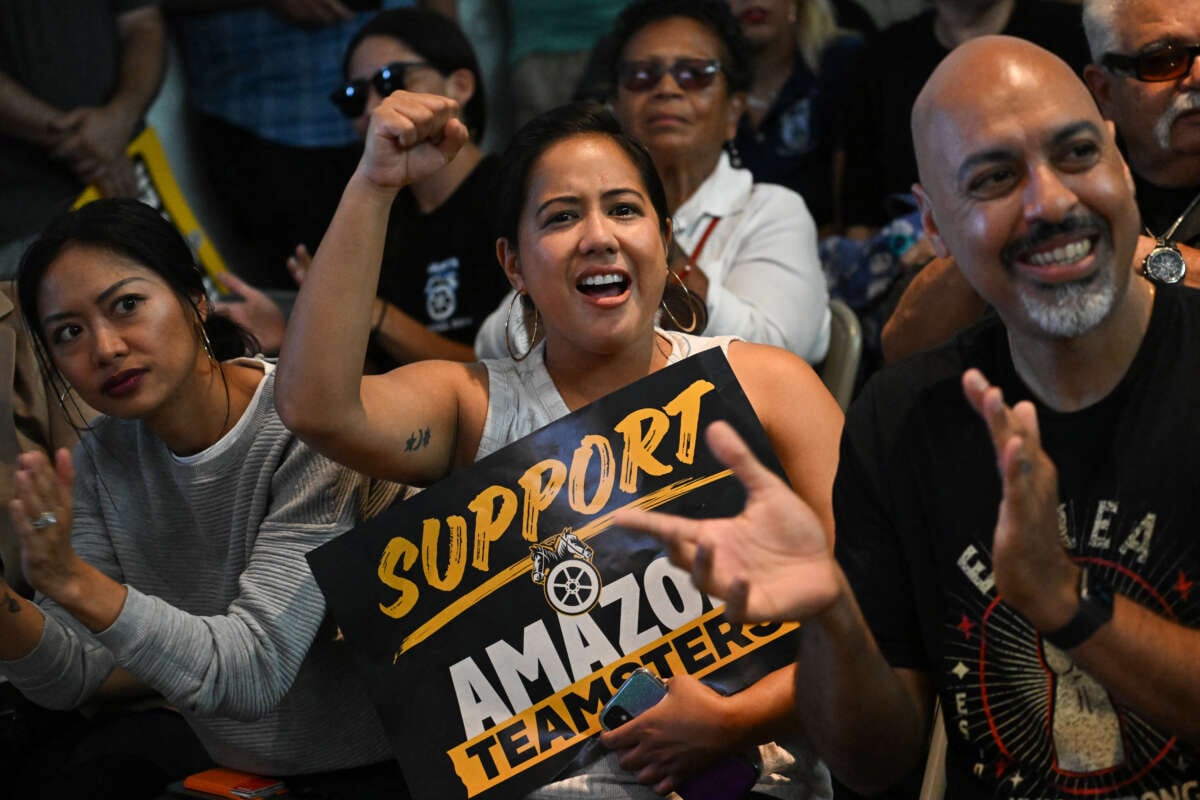 An attendee holds a Support Amazon Teamsters sign during a rally with workers and union members as part of an "Amazon Teamsters Day of Solidarity" in support of the unionization and collective bargaining of Amazon delivery drivers at the Teamsters Local 848 on August 29, 2024, in Long Beach, California.