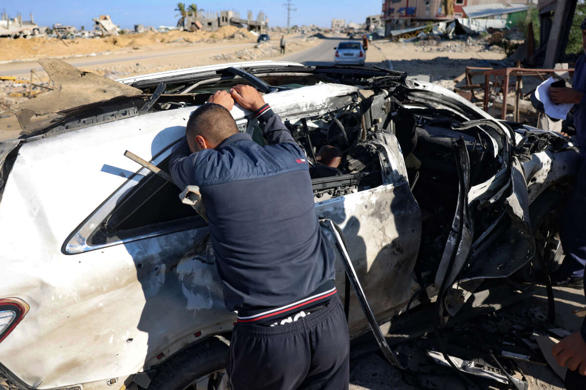 A man reacts in front of a car hit by an Israeli strike in Khan Yunis in the southern Gaza Strip on November 30, 2024, in which five people were reported killed, including three World Central Kitchen workers, according to a report by the civil defense in the Palestinian territory.