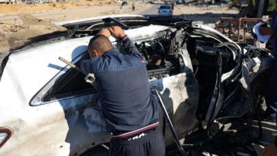 A man reacts in front of a car hit by an Israeli strike in Khan Yunis in the southern Gaza Strip on November 30, 2024, in which five people were reported killed, including three World Central Kitchen workers, according to a report by the civil defense in the Palestinian territory.