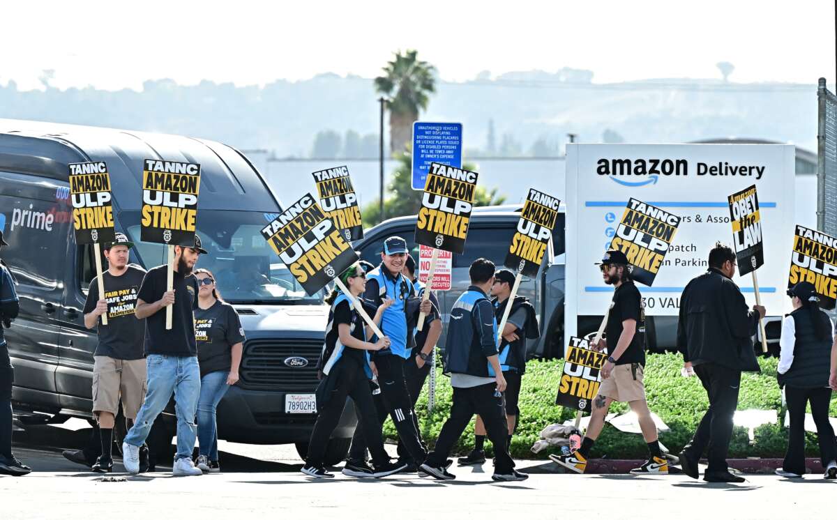 Amazon workers walk the picket line outside an Amazon facility in the City of Industry, California, on December 19, 2024.