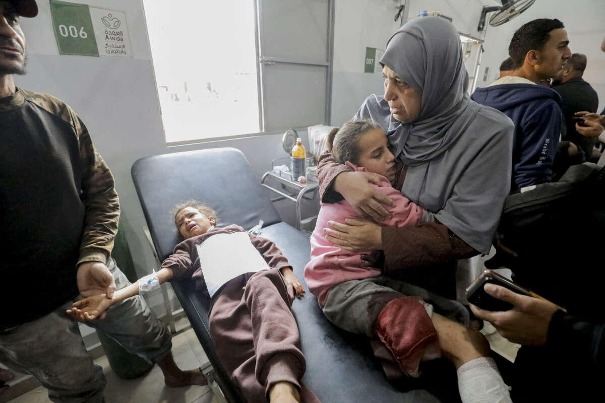 A mother holds her injured child close at Al Awda Hospital in Nuseirat, Gaza, on December 17, 2024.