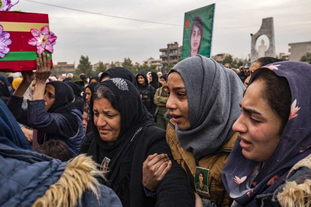 People mourn during the funeral procession of a member of the Women's Protection Units (YPJ), who was killed during a Turkish drone strike in the countryside of Kobani a day earlier, in Syria's northeastern city of Qamishli, on December 22, 2024.