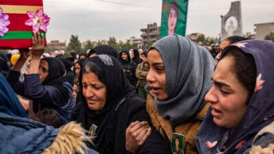 People mourn during the funeral procession of a member of the Women's Protection Units (YPJ), who was killed during a Turkish drone strike in the countryside of Kobani a day earlier, in Syria's northeastern city of Qamishli, on December 22, 2024.