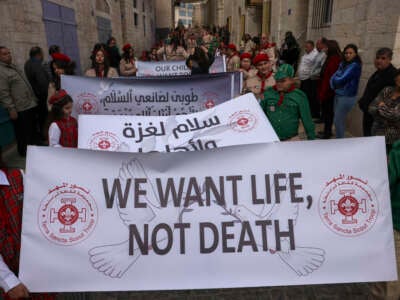 Palestinians partake in the yearly Christmas procession towards the Church of the Nativity in Bethlehem town in the Israel-occupied West Bank on December 24, 2024.