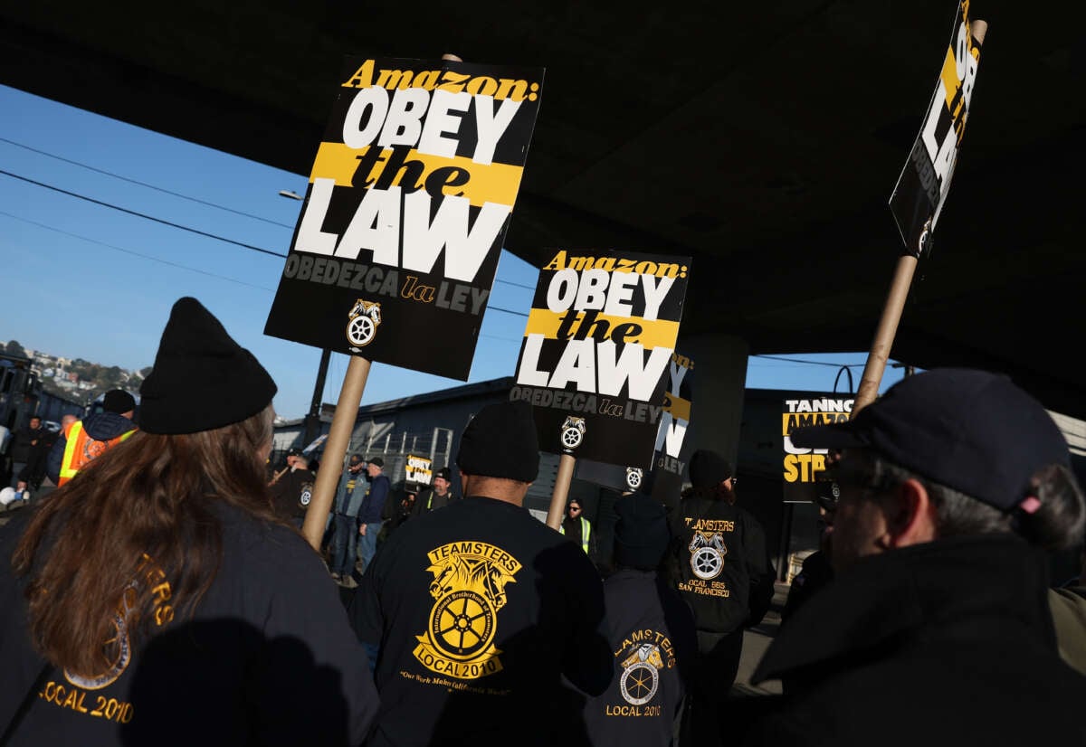 Amazon Teamsters union workers picket outside an Amazon distribution center on December 19, 2024, in San Francisco, California. Thousands of Amazon Teamsters union workers have walked off the job and are striking at Amazon facilities across the United States before the busy holiday gift-giving season.