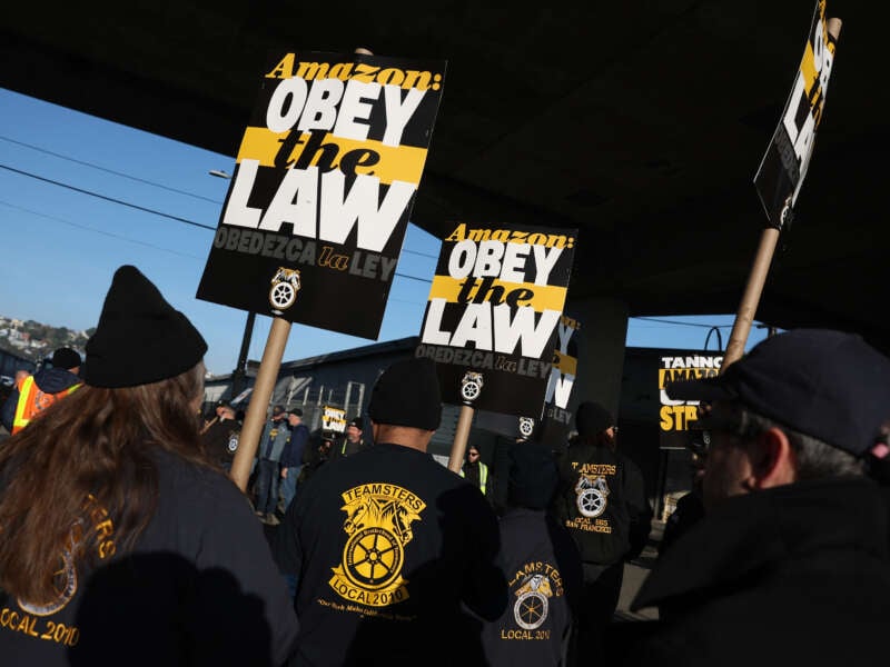 Amazon Teamsters union workers picket outside an Amazon distribution center on December 19, 2024, in San Francisco, California. Thousands of Amazon Teamsters union workers have walked off the job and are striking at Amazon facilities across the United States before the busy holiday gift-giving season.