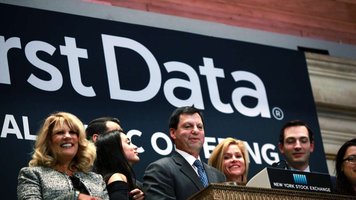 First Data Corporation CEO Frank Bisignano (center) looks around the New York Stock Exchange after ringing the opening bell to celebrate First Data's initial public offering on October 16, 2015, in New York City.