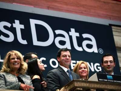 First Data Corporation CEO Frank Bisignano (center) looks around the New York Stock Exchange after ringing the opening bell to celebrate First Data's initial public offering on October 16, 2015, in New York City.